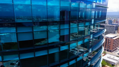modern blue glass skyscraper in a cityscape
