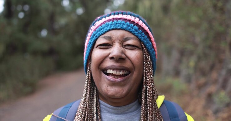 Smiling Mature Woman Wearing a Colorful Knit Hat Outdoors