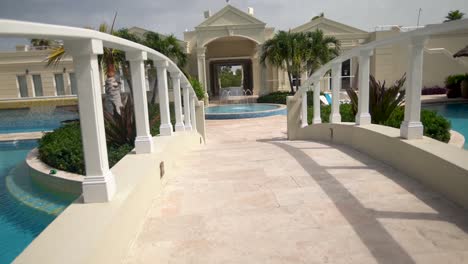 Walking-on-a-bridge-over-a-beautiful-pool-courtyard