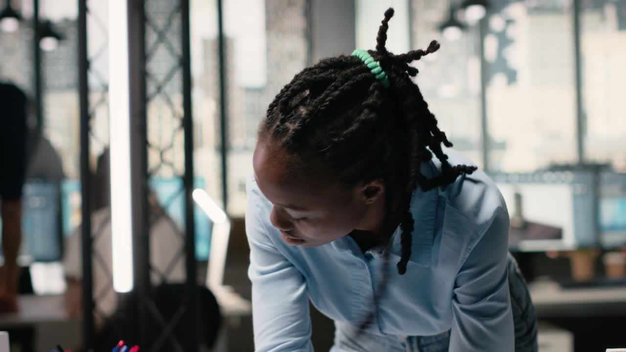 Vertical Video African american contractor reviewing architectural 3D models for the future