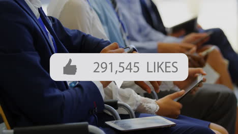 speech bubble with thumbs up icon and increasing numbers against people using electronic devices