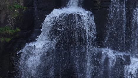 water flowing down a tranquil rocky waterfall