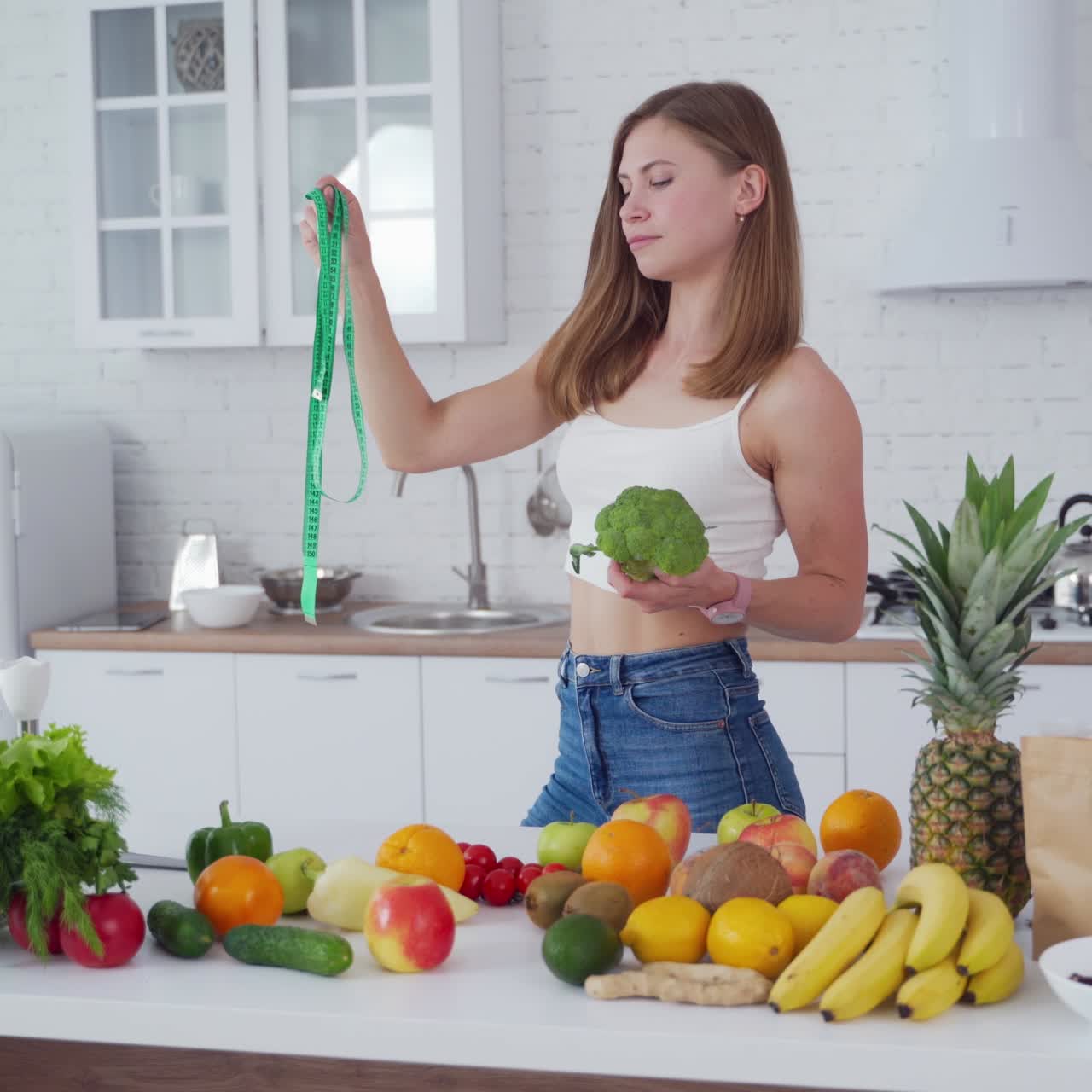 Sporty woman standing near fruits