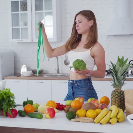 sporty woman standing near fruits
