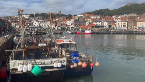 fishing boats rest at scarborough harbour, highlighting a vibrant fishing community with beautiful coastal scenery.
