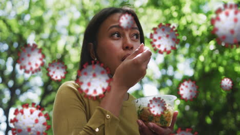 animation of covid 19 cells over woman eating lunch in city with face mask