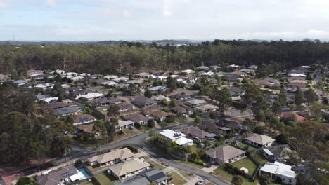 Drone-flying-over-residential-estate-revealing-private-homes-and-solar-panels-on-many-homes