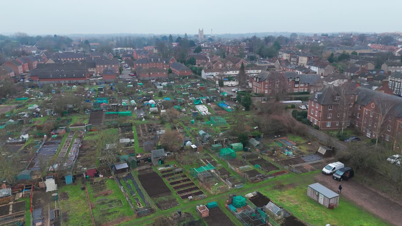 Flight over allotments with views of Bury st edmounds cathedral