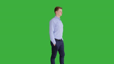 young caucasian man standing against green screen background. male person isolated on chroma key. casual business professional portrait