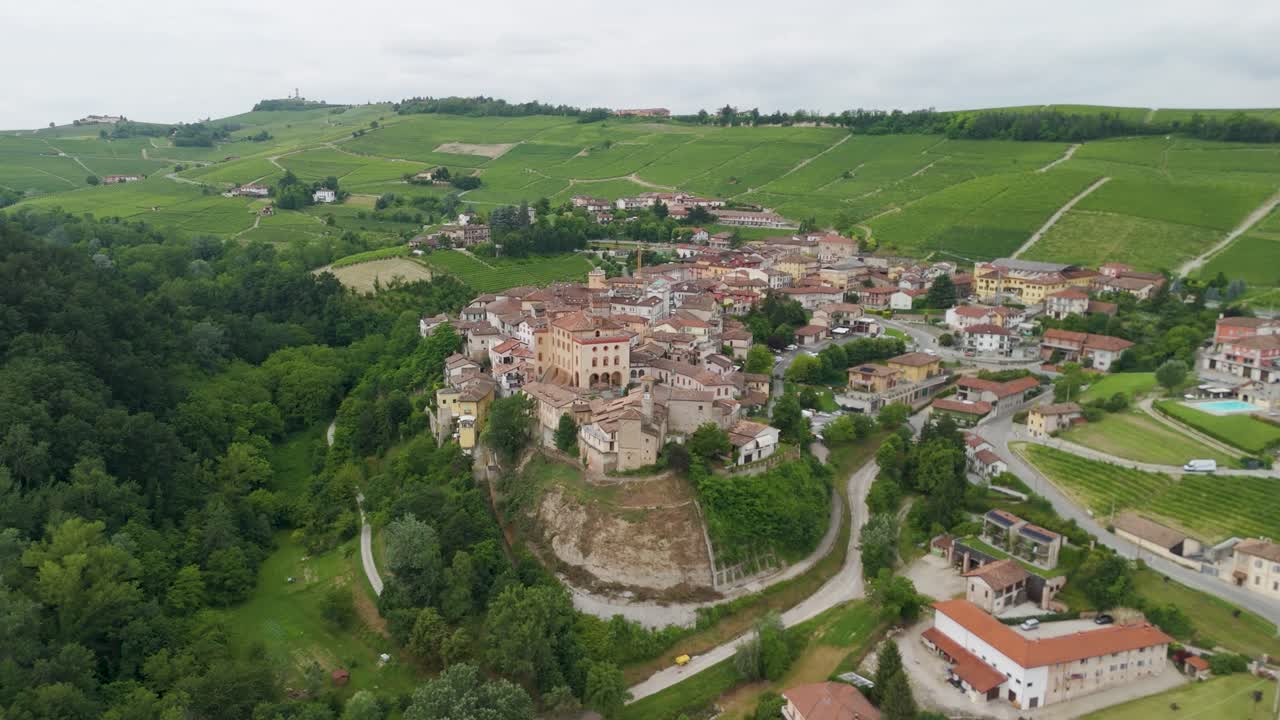 Barolo Castle in Langhe Wine Region, Cuneo, Piedmont, Italy. 4K Aerial view of the village and the vineyards moving forward.