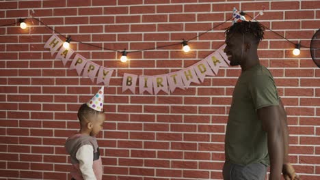 dad and son playing ballon on birthday party at home