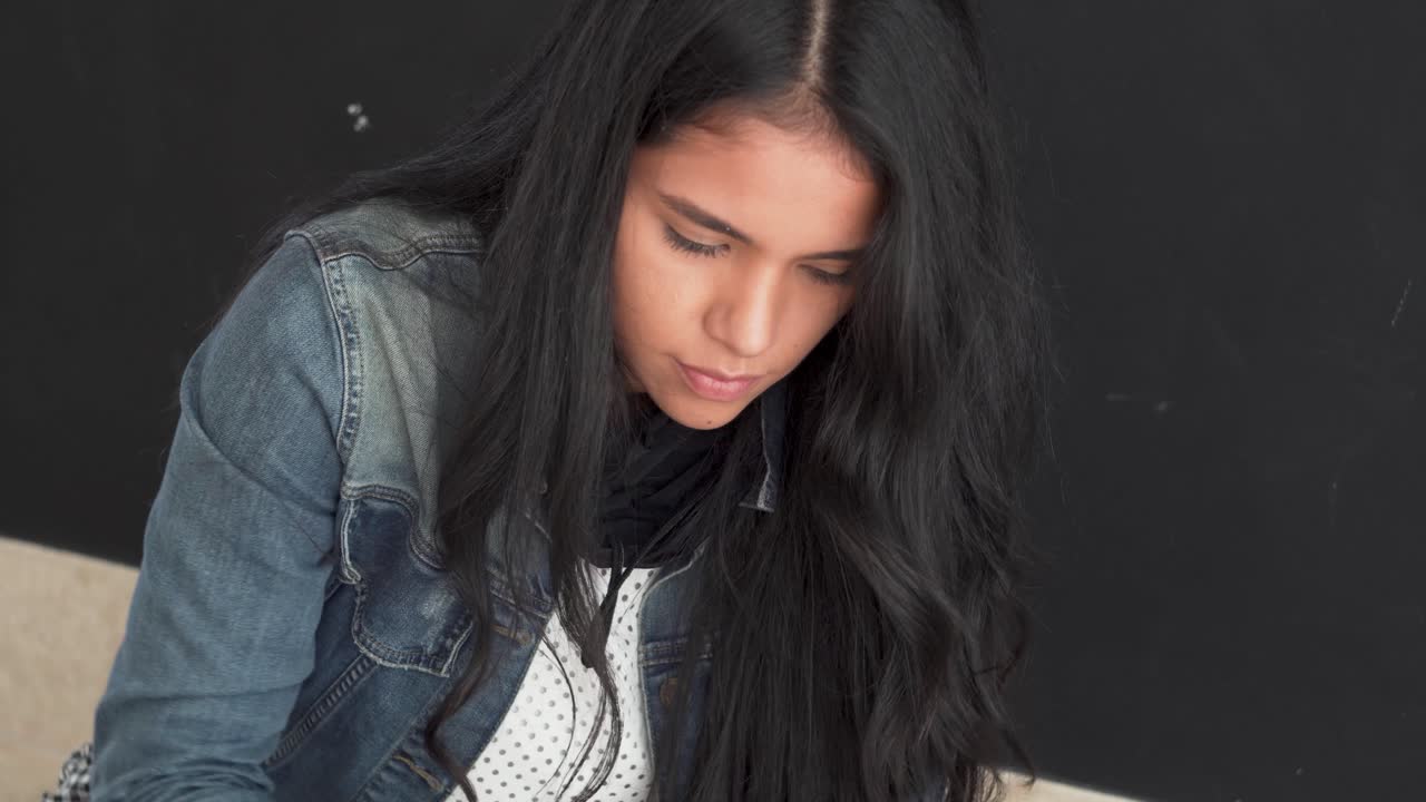 행복하고 아름다운 젊은 라티나 소녀가 디자이너 프로젝트에 참여하고 있습니다.