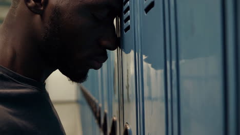 teenager feeling sad near school lockers
