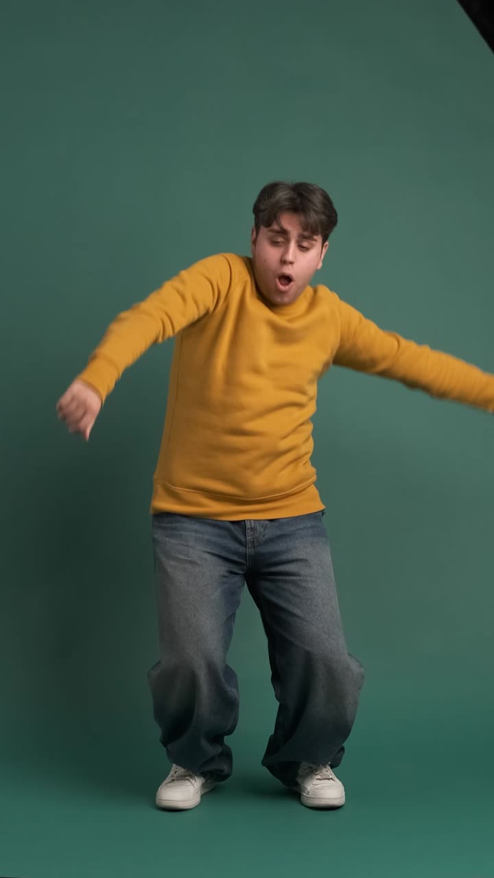 Cheerful ethnic young man doing dance moves