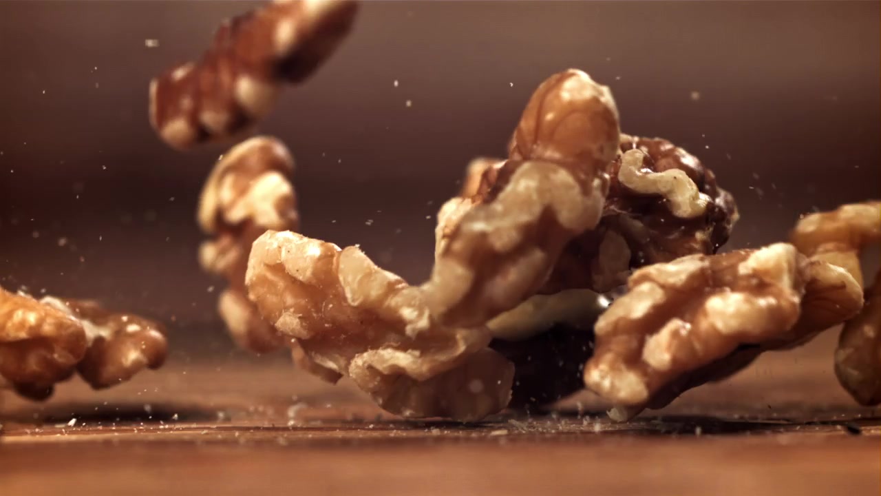 Walnuts Falling in Slow Motion onto a Wooden Surface