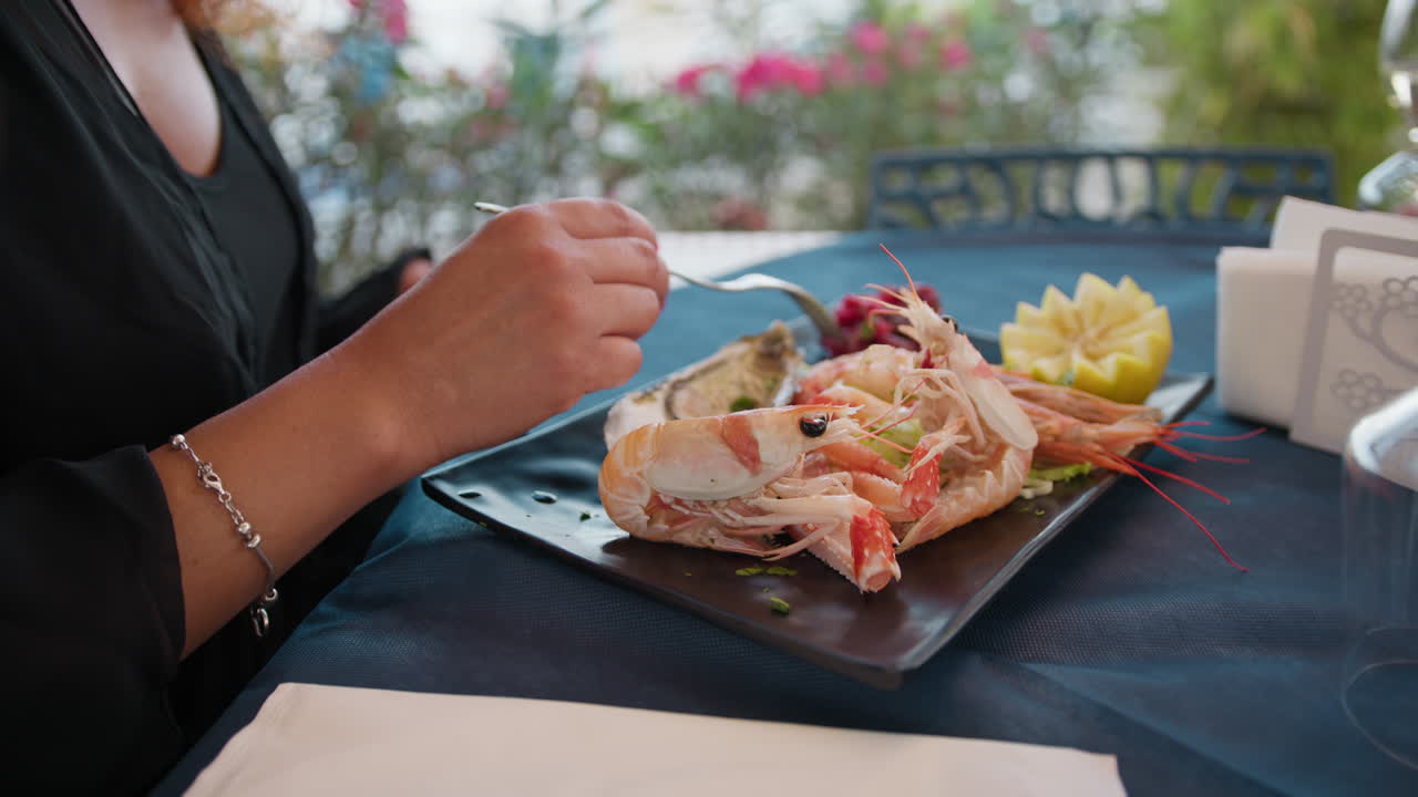 Woman Starting To Eat The Dish With Lobster At The Beach Resort