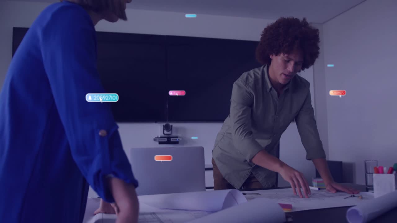 Male architect leaning over blueprints in conference room, with floating digital data labels