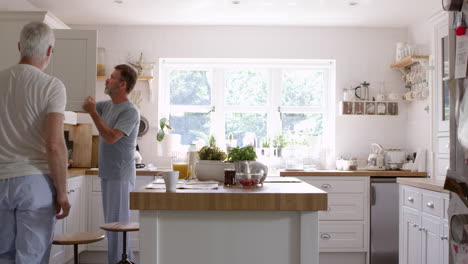 male homosexual couple having breakfast at home together