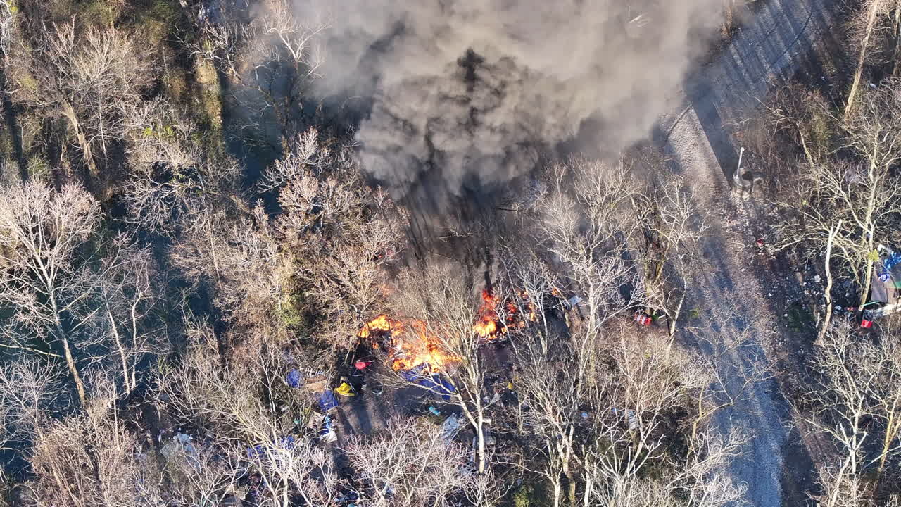 Close up aerial footage of a fire in the middle of the forest next to a stream in Chattanooga, TN.