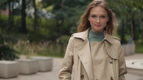 Caucasian-woman-looking-at-the-camera-and-smiling-outdoors.