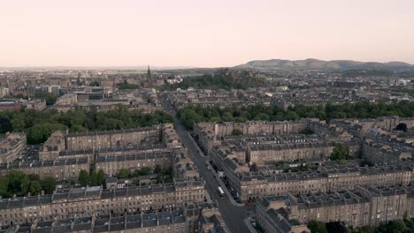 Panorama aerial fly over Edinburgh New Town in golden hour with orange skys, Edinburgh, Scotland, UK