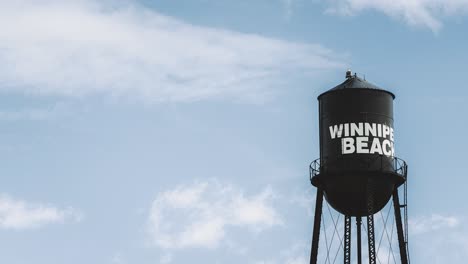 A-Zooming-Shot-of-Winnipeg-Falcon-Beach-Black-and-White-Painted-Vintage-Metal-Water-Tower-Travel-Tourist-Destination-Against-a-Blue-Summer-Sky-in-Gimli-Manitoba-Canada