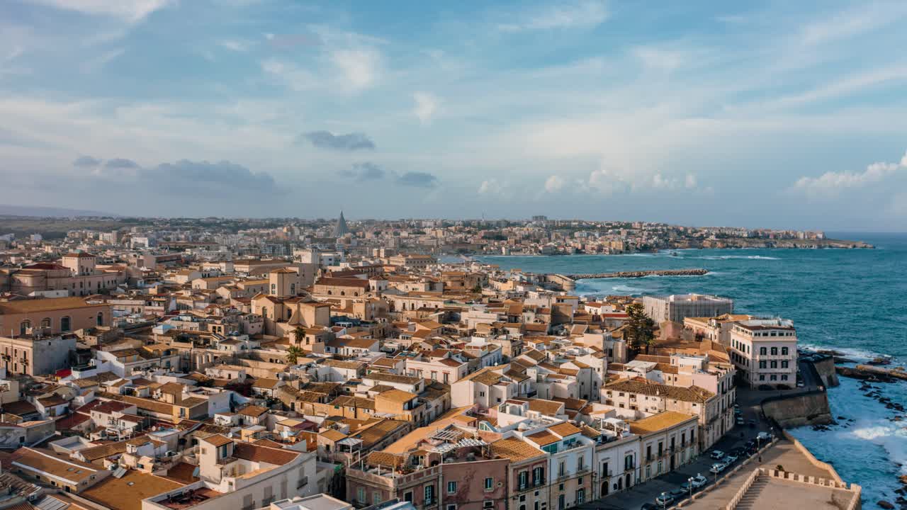 High amplitude aerial hyperlapse over Ortigia island in Sicily. Medieval town by the Mediterranean sea with historic buildings in Italian landscape. UNESCO world heritage site.