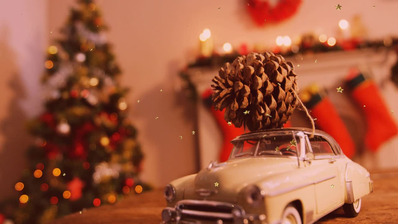Camera framing mini vintage car with pine cone while gold flakes drifting, adding festive depth