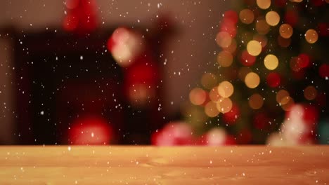 Composición-De-Video-Con-Nieve-Cayendo-Sobre-Un-Video-Borroso-De-Luces-De-árbol-De-Navidad-Y-Escritorio-En-Frente