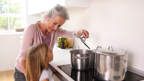 Girl-happily-cooking-with-her-grandmother-