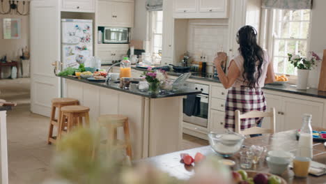 happy overweight teenage girl dancing in kitchen having fun celebrating weekend performing funny dance moves listening to music wearing headphones