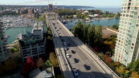 daytime traffic on burrard street bridge crossing false creek in vancouver, bc, canada. drone shot