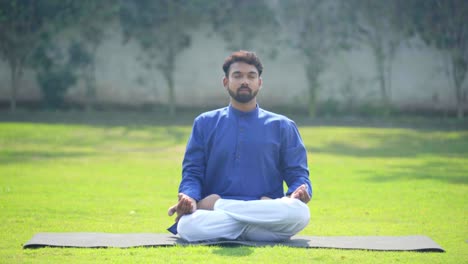 indian man doing pranayam yoga