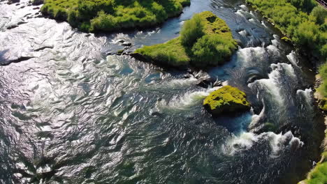 aerial view of river rapids with green islands