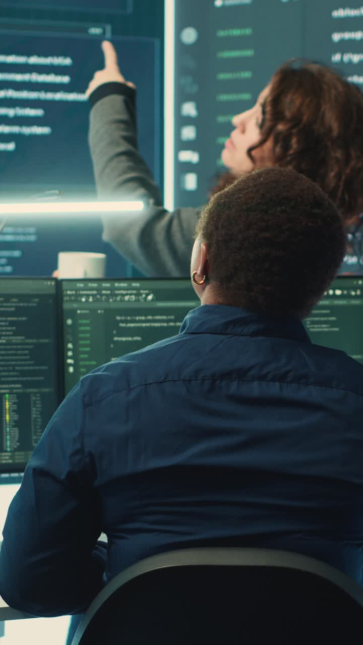 Female Programmers Collaborating on Software Development in Dark Office