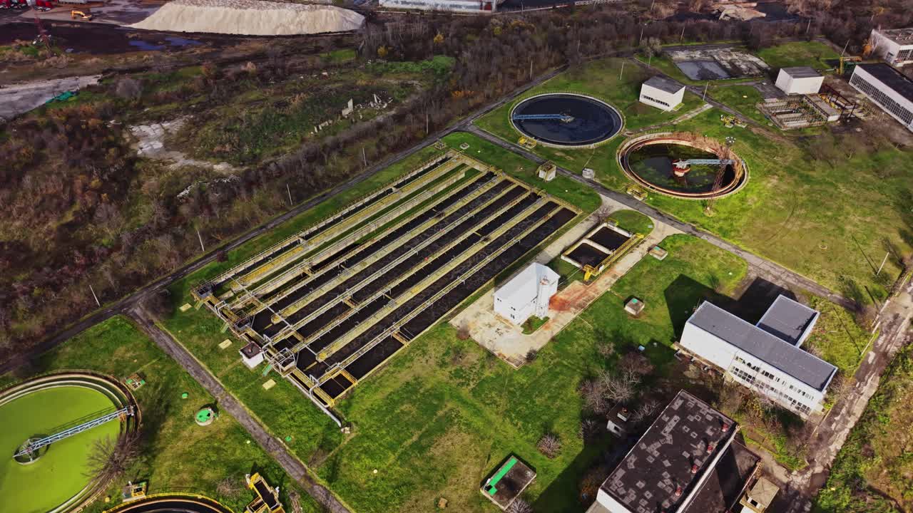 Water treatment plant operates with various tanks and buildings in the area