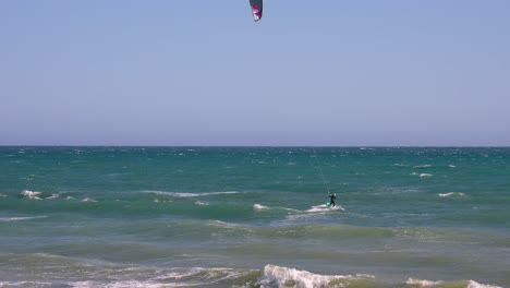 man kiteboarding in the ocean