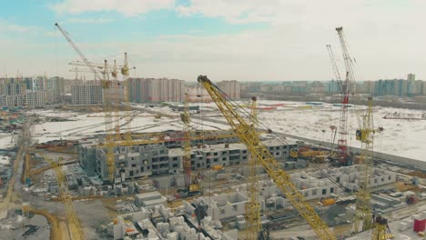 view of undone project with yellow construction cranes