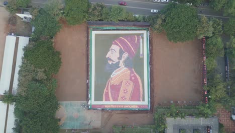 aerial shot of beautiful colorful indian traditional rangoli of chhatrapati shivaji maharaj with dry flour and colored sand nashik drone 4k