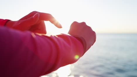 fitness watch in sun flare on hispanic female