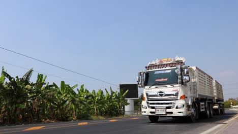 a large truck driving down a sunny highway