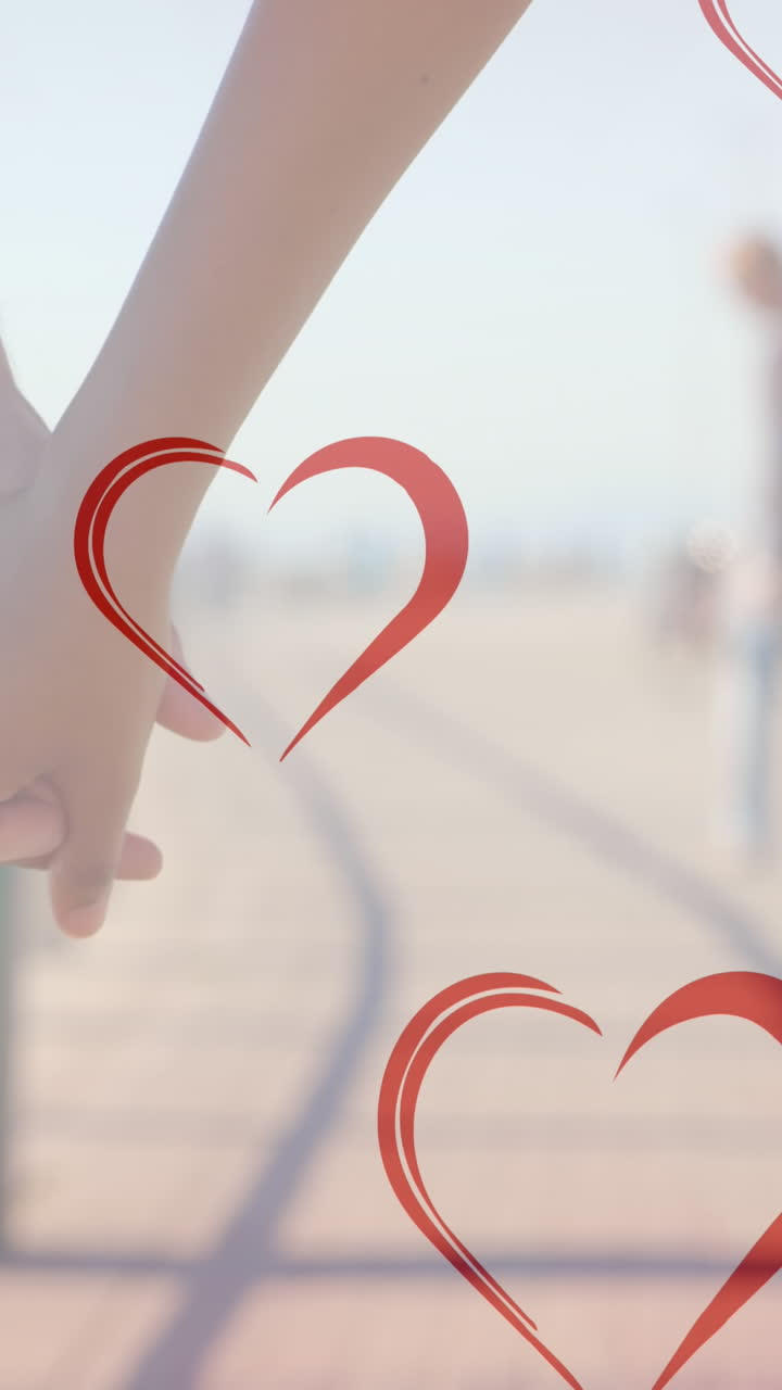 animación de corazones cayendo sobre parejas diversas tomadas de la mano