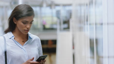 beautiful-hispanic-business-woman-using-smartphone-texting-messages-on-mobile-phone-sending-email-communication-networking-online-at-work-in-office