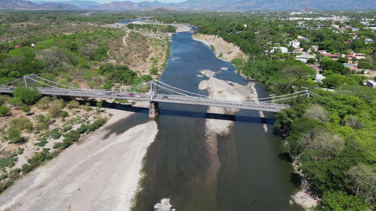 Aerial view of Choluteca cityscape with historic suspension bridge, Honduras, Central America