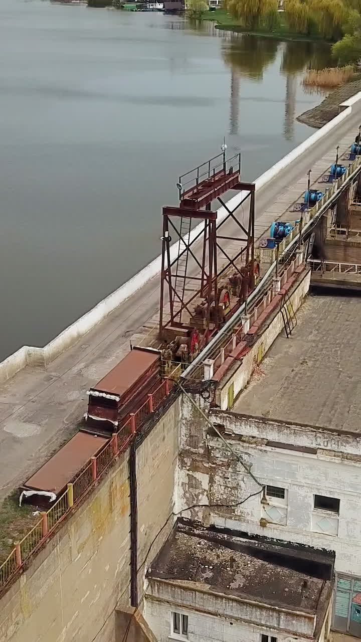 View of the treatment plant from above. Wastewater. Water sewage plant is on the river outside the city. Camera motion to right. Aerial view. Vertical video