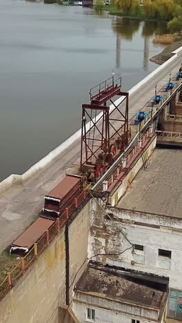 view of the treatment plant from above. wastewater. water sewage plant is on the river outside the city. camera motion to right. aerial view. vertical video