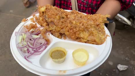 deep fried bhetki fish kabiraji served with kasundi and mayonese in a road side stall in kolkata.