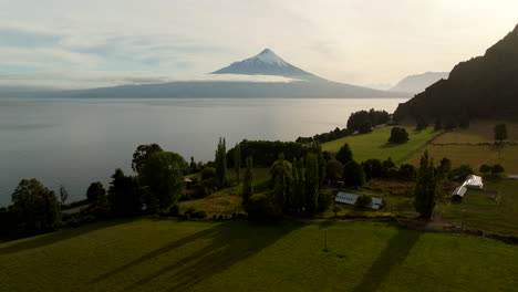 aerial dolly, sunrise landscapes, farmland buildings, lake llanquihue