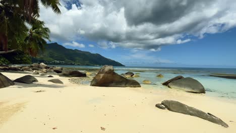 Mahe-seychelles,-white-sandy-beach-with-granite-rocks,-low-tide,-white-sandy-beach