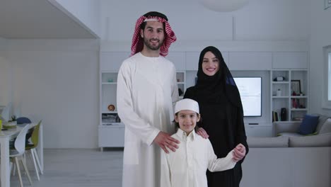 muslim family with kid in modern home
